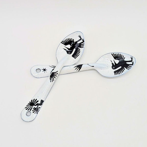 set of two bird-like creatures (nahual) with long beaks and distinctive features on the enamelware peltre metal spoon