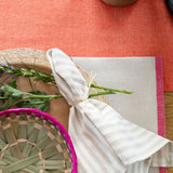 Stripped White/Beige Cotton Napkin on round Palm Placemat on Cotton rectangular placemat.