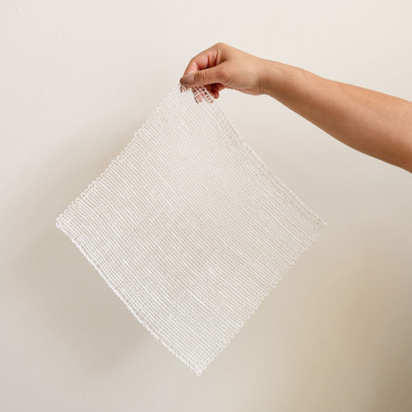 Plastic Free Ayate Washcloth woven with agave fibers held by a hand.