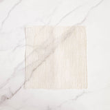 Woven Agave fiber ayate washcloth on a marble background