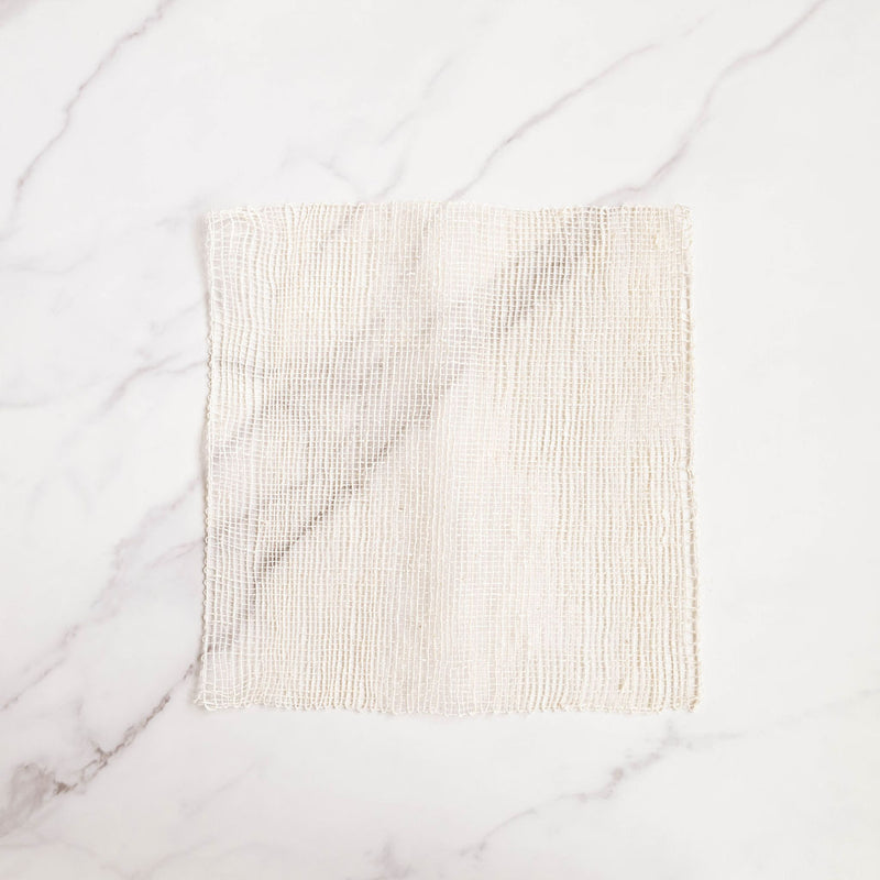 Woven Agave fiber ayate washcloth on a marble background