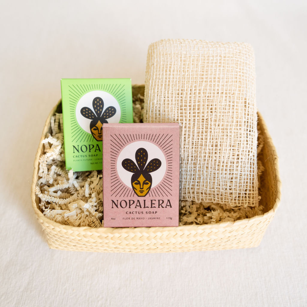 Gift basket for bathing rituals featuring a Nopalera Planta Futura Soap Bar, Nopalera Noche Clara Soap Bar, agave ayate washcloth, and a handcrafted palm basket. Perfect for self-care routines, with natural, artisanal items for a luxurious bathing experience.