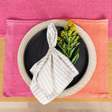 Color Block Pink/Orange Cotton Placemat top view with striped napkin and  flower