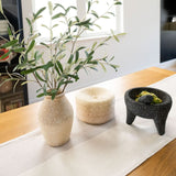 Color Block White/Beige Cotton Table Runner on wood table styled with a tortillero, vase with green branches, and a molcajete