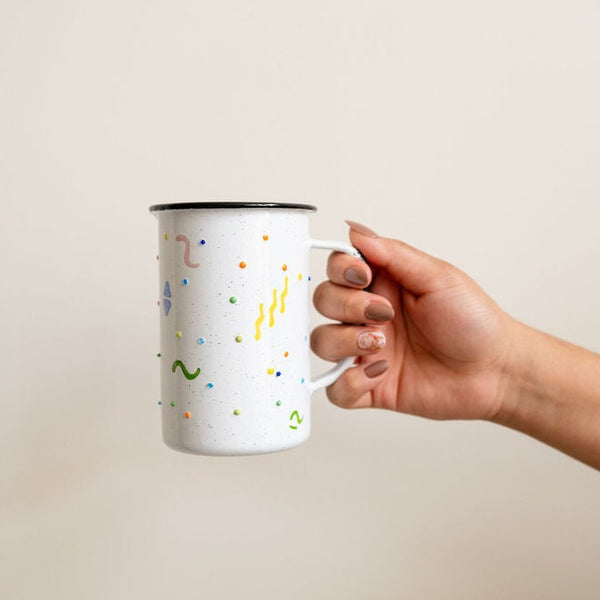 Tall Enamel Coffee Cup (Mexican Peltre style) with colorful confetti dots held by a hand