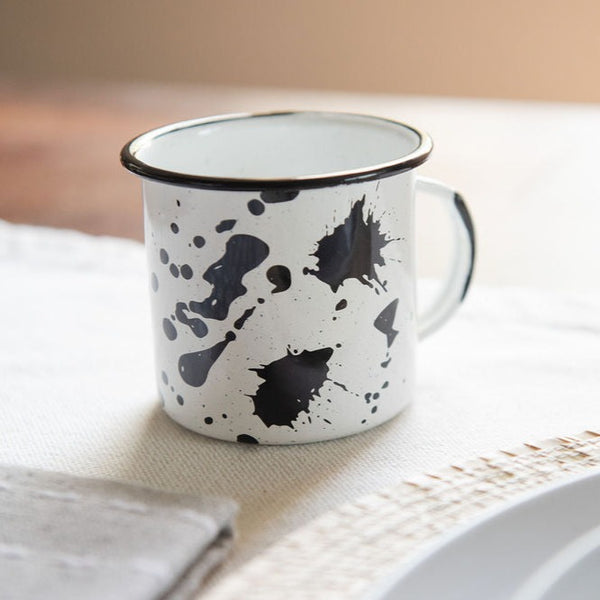 enamel Peltre cup in modern mexican designs with black spots on dinner table