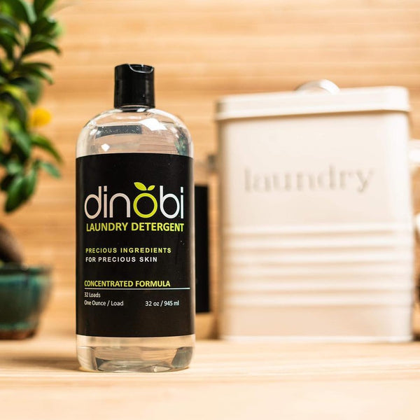 Dinobi's plant-based laundry detergent for sensitive skin in laundry room