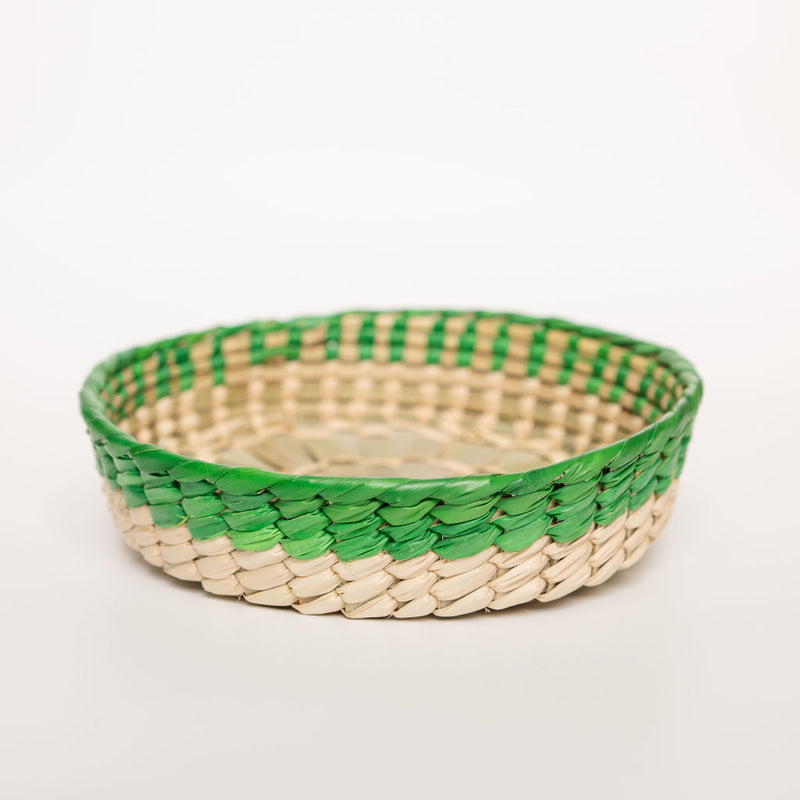 Mexican woven palm basket with green (Emerald Green) color rim and natural bottom on white background