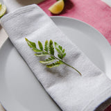 Light Grey Cotton dinner napkin on a place setting on a table 
