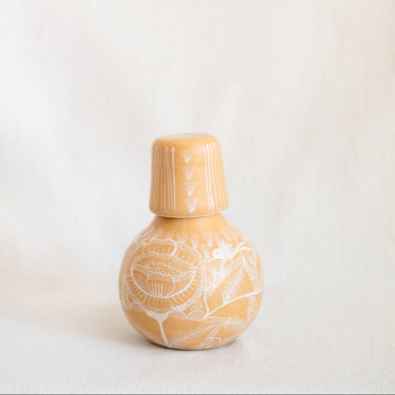 Huancito ceramic botellon carafe with lid and floral design on a plain background