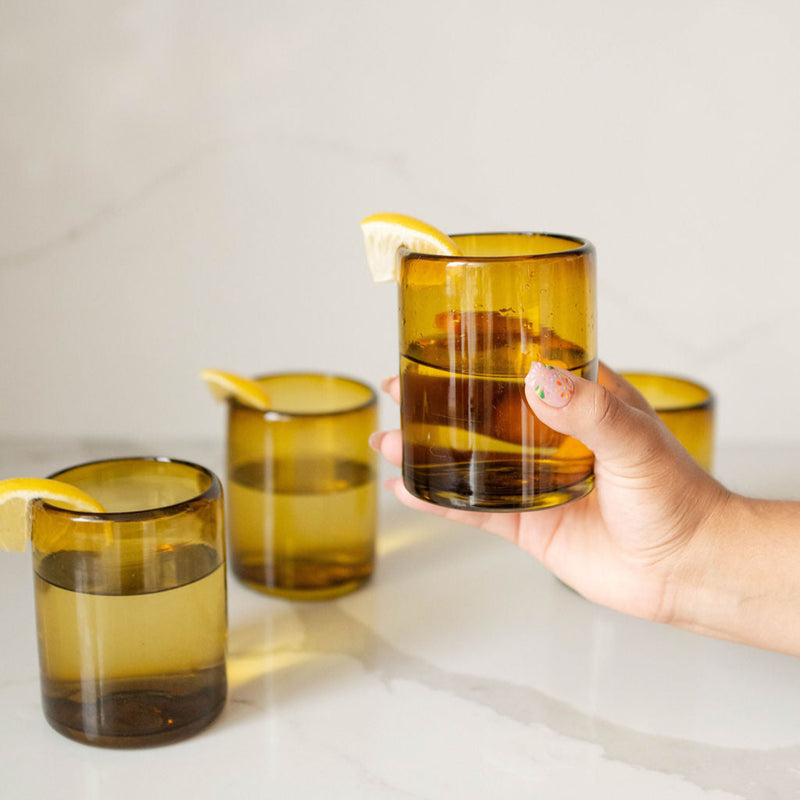 Mexican Handblown Recycled Glass Cups - Amber Gold with a hand holding a cup