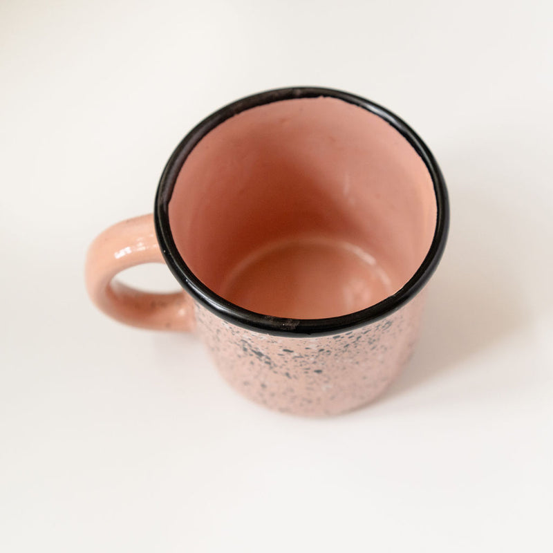 Top view of pink Speckled Ceramic Coffee Mug (Mexican peltre style) with Black Rim on white background