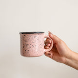 Pink Speckled Ceramic Coffee Mug (Mexican peltre style) with Black Rim held by a hand