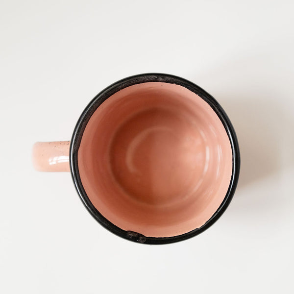 Top view of pink Speckled Ceramic Coffee Mug (Mexican peltre style) with Black Rim on white background