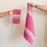 A vibrant Set of Two Rosa Mexicano (Pink) Casa Oaxaca Woven Cotton Napkins, showcasing artisanal craftsmanship from Oaxaca, Mexico, with a soft, durable texture perfect for adding a pop of color to any table setting. This eco-friendly, 100% cotton napkin is handwoven, blending sustainable design with traditional Mexican culture.