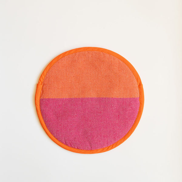 A vibrant Rosa Mexicano pink and orange color block handwoven cotton tortilla warmer, perfect for keeping tortillas warm while adding a pop of color to your table. This eco-friendly, artisan-made kitchen accessory is crafted from sustainable materials, reflecting Mexican cultural heritage and zero-waste values.