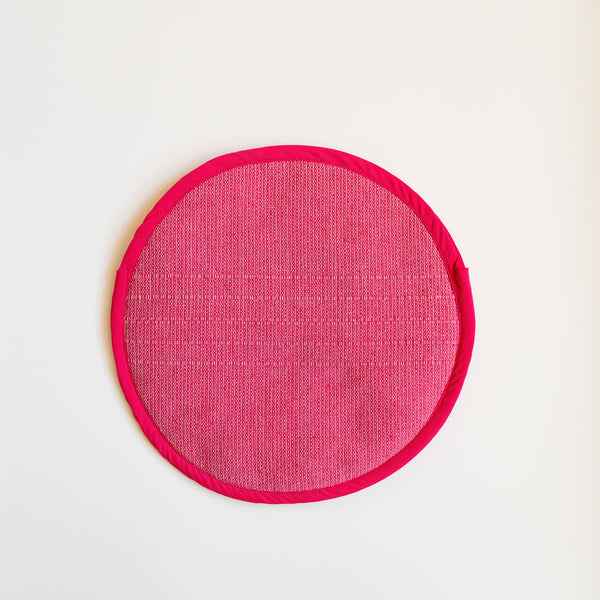 A vibrant Rosa Mexicano pink color block handwoven cotton tortilla warmer, perfect for keeping tortillas warm while adding a pop of color to your table. This eco-friendly, artisan-made kitchen accessory is crafted from sustainable materials, reflecting Mexican cultural heritage and zero-waste values.