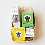 Gift basket with 5 Latina-owned, clean beauty products such as Nopalera, Paca Botanica, Volverde and Sanara Skincare on a white background