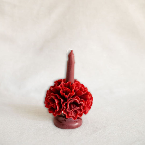 A handcrafted Oaxacan beeswax candle in a rich red burgundy, featuring intricate floral designs that showcase traditional artistry. This self-standing candle brings a touch of Mexico's cultural heritage to your home, perfect for sustainable and eco-friendly décor.