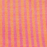 A close up of handwoven cotton napkins in orange and rosa mexicano (pink) stripes. Ethically made.