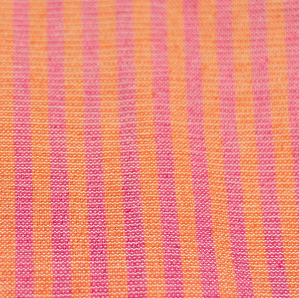 A close up of handwoven cotton napkins in orange and rosa mexicano (pink) stripes. Ethically made.