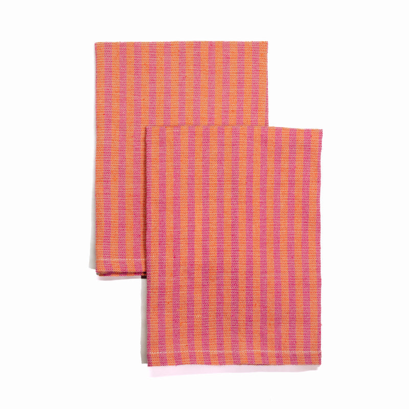 These handwoven cotton napkins are a perfect pop of color that celebrate Mexican design. Melon and Rosa Mexicano striped napkin. Ethically made.