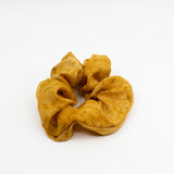 Yellow silk scrunchie handmade and dyed with natural dyes made of cempasuchil (marigold) by a Oaxacan artist.
