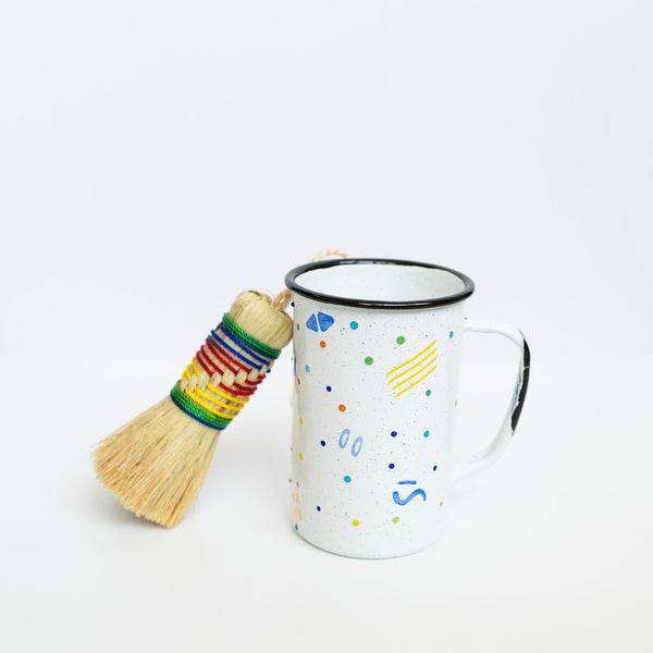 Agave Cleaning Brush (Escobeta) with rainbow string and a tall enamel mexican peltre cup with confetti dots 