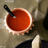 Terracotta ceramic clay (barro) bowl with pointed  spike rim on a table setting