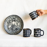 handcrafted handmade Ceramic plate with artistic design and three matching mugs on a white background