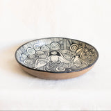 Black ceramic plate from Tzintzuntzan Michoacan with black and white design on a white background