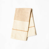 A folded cream-colored kitchen towel with thin terracotta stripes, displayed on a clean white background.