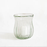 A clear ribbed Mexican handblown glass candle holder or hurricane with a flared rim, photographed against a plain white background.