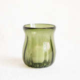 A small translucent olive green glass candle holder with a flared rim and ribbed base, shown on a plain white background.