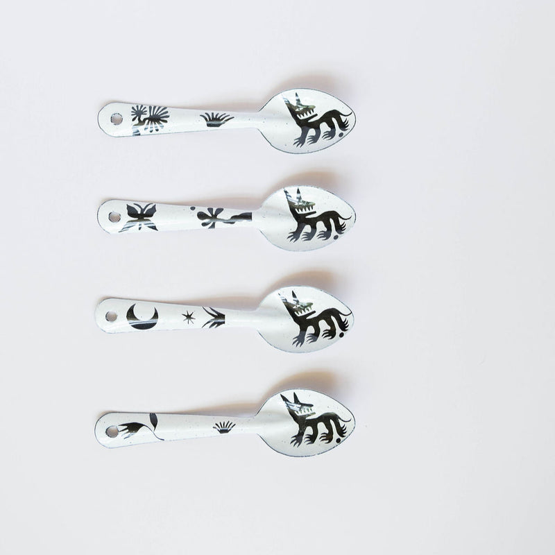 set of four stylized dog or wolf-like creature (nahual) with sharp teeth and distinctive features on the enamelware peltre metal spoon