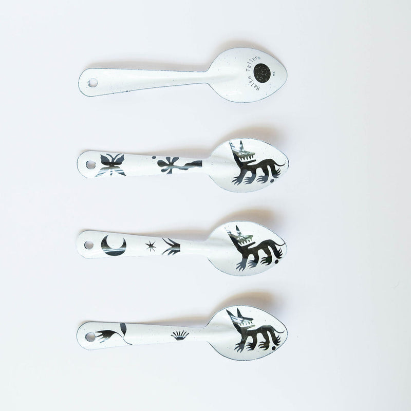 set of four stylized dog or wolf-like creature (nahual) with sharp teeth and distinctive features on the enamelware peltre metal spoon