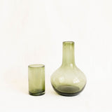 Round olive green glass carafe with a matching lid that serves as a cup