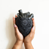 Hands Holding a Mexican Barro Negro Ceramic Anatomical Heart Wall Art Sculpture