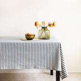 Hunter Green striped cotton woven tablecloth with glass vase, flowers and bowl on the table