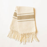 Beige and brown striped cotton hand towel with fringes on a white background