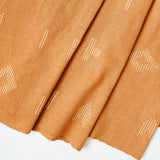 Close up of terracotta cotton woven table runner with white geometric woven figures from Mitla, Oaxaca