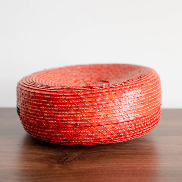 Side View of an orange Round Handwoven Natural Palm Tortilla Warming Basket (tortillero) with Lid