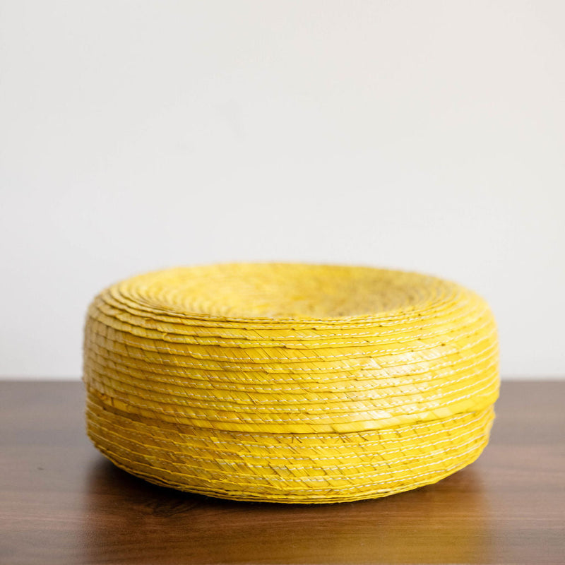 Side View of a yellow Round Handwoven Natural Palm Tortilla Warming Basket (tortillero) with Lid