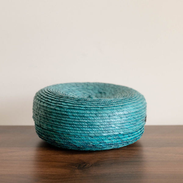 Side View of an emerald green Round Handwoven Natural Palm Tortilla Warming Basket (tortillero) with Lid