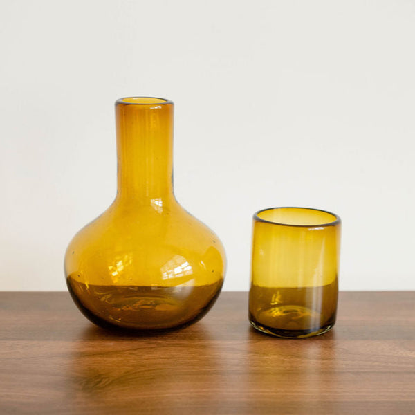 Handblown Glass Carafe with a lid in Ambar Gold. The Lid also doubles as a functional cup. The carafe can also be used as a vase for your beautiful flowers.