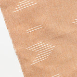 Brown cotton hand towel with white geometric patterns on a white background