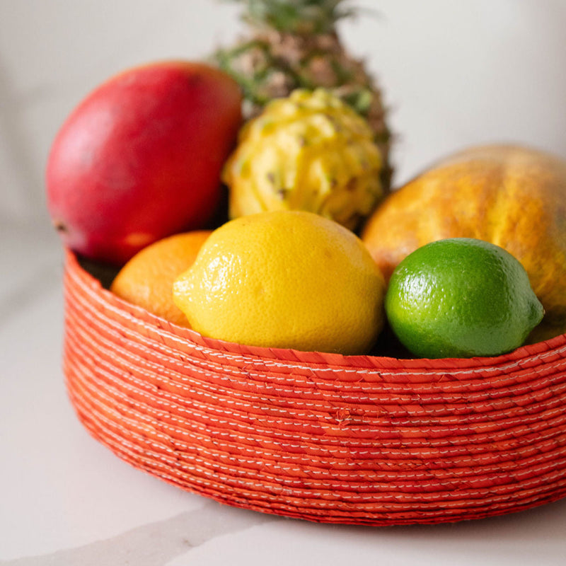 Sustainable Eco-friendly Palm Fruit Basket (Frutero) - orange styled with fruit on a marble countertop.