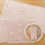 Cotton Table Runner styled with plates palm placemats and matching cotton napkin. 
