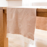 Handwoven Cotton Table Runner with fringe on wood table