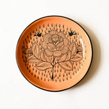 Peach Ceramic plate with a floral design on an white background